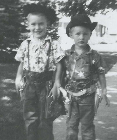 4- and 2-year olds with cowboy hats and guns 4- and 2-year olds with cowboy hats and guns